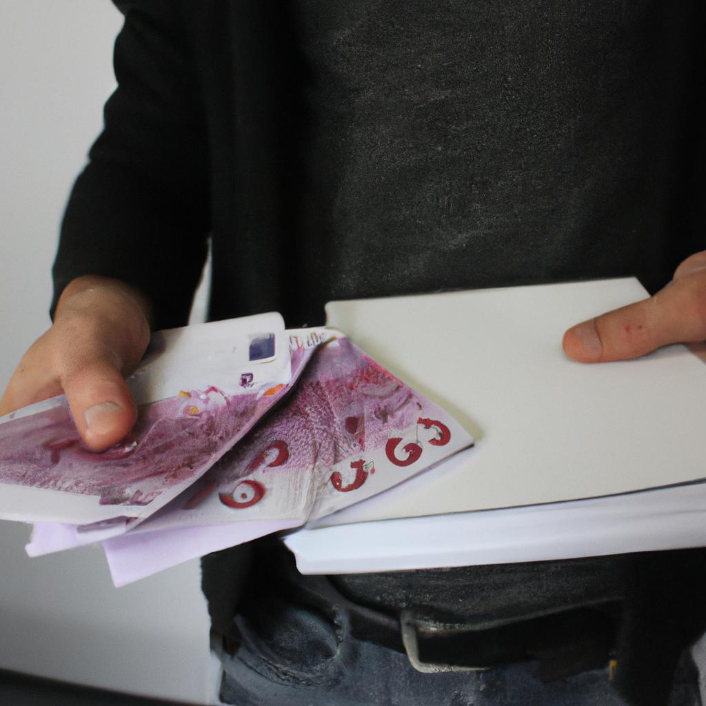Person holding money and documents