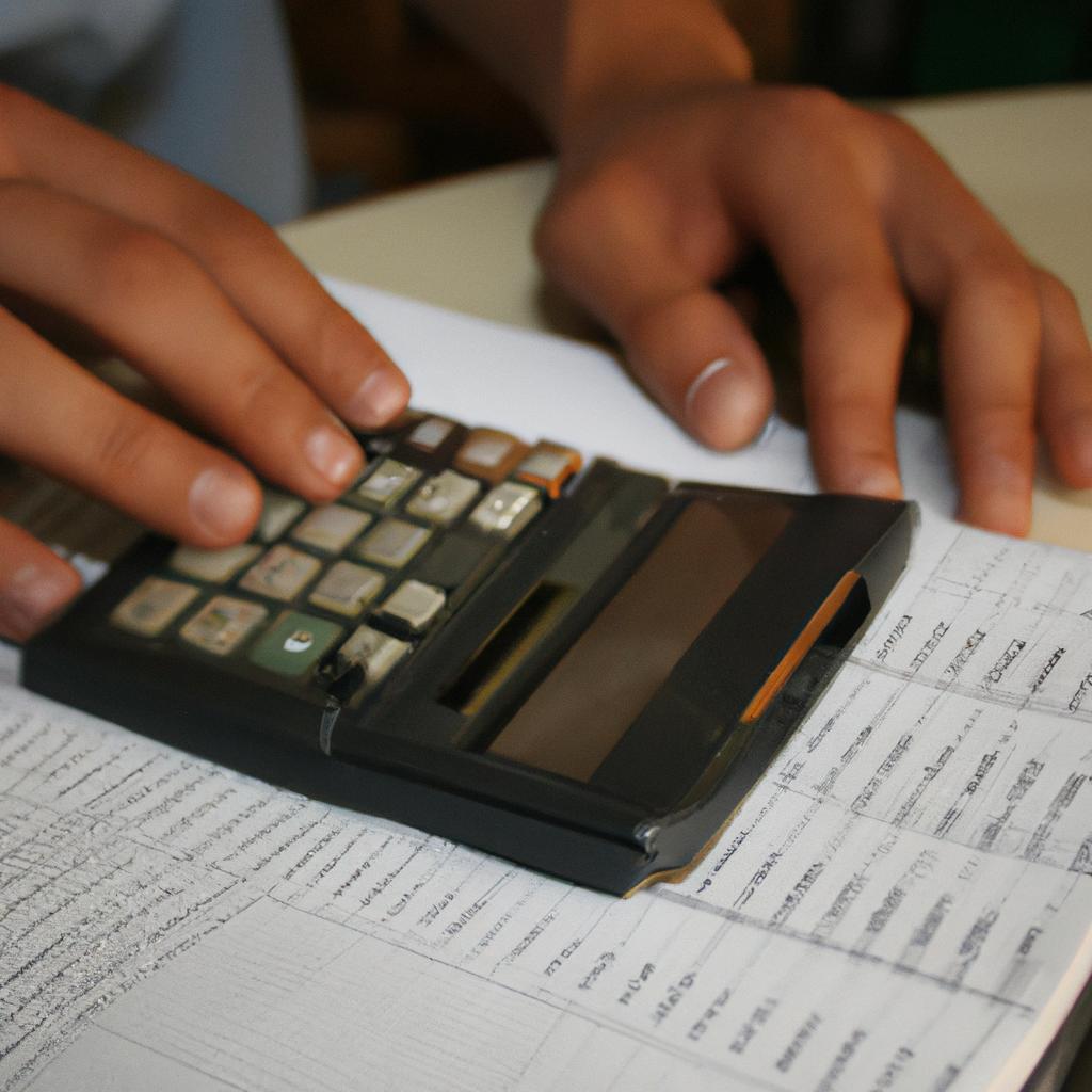 Person holding calculator, analyzing documents
